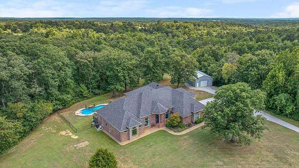 7.6 Acres of Land with Home for Sale in Gravette, Arkansas
