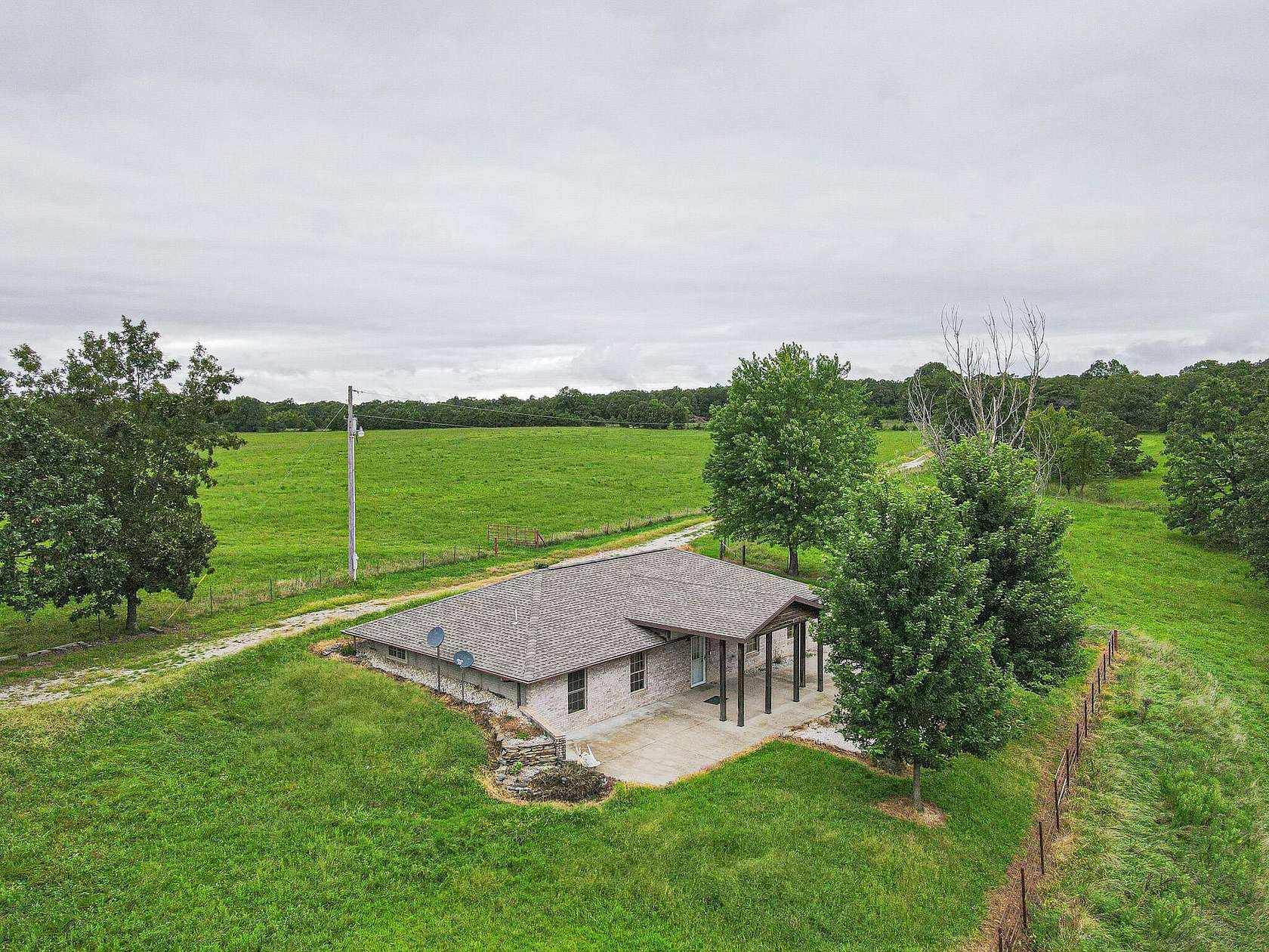 40 Acres of Agricultural Land with Home for Sale in Macks Creek, Missouri