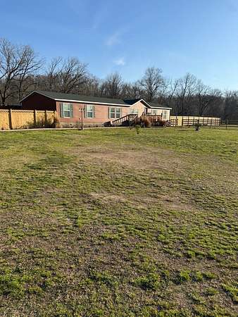 18.1 Acres of Land with Home for Sale in Gravette, Arkansas