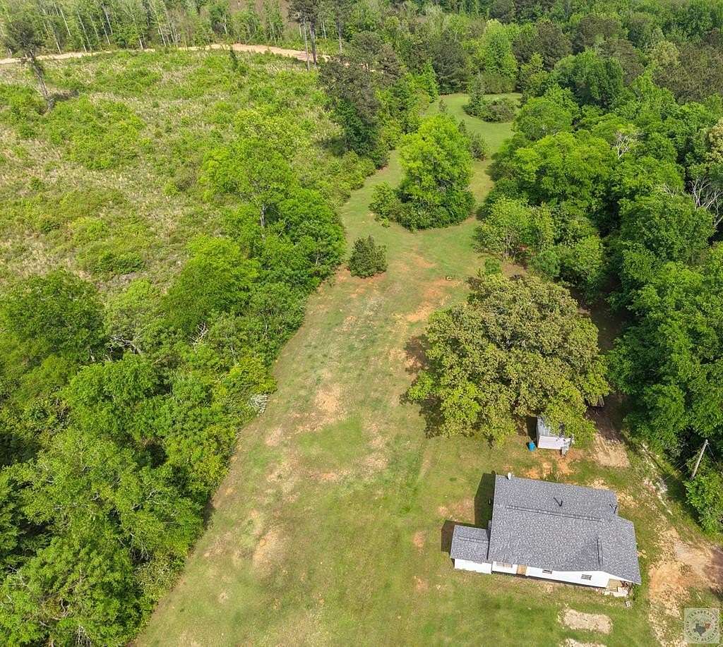 6.4 Acres of Land with Home for Sale in Atlanta, Texas