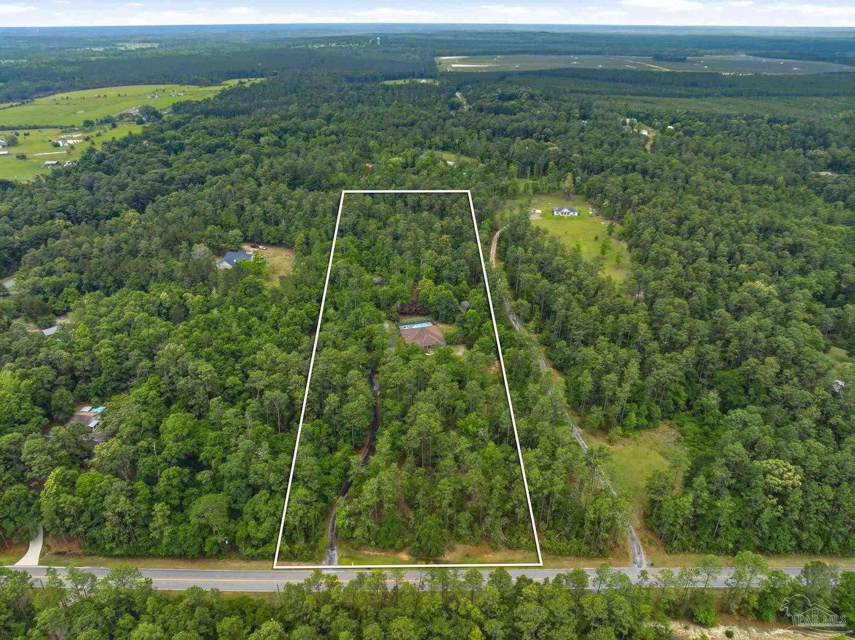 9.72 Acres of Land with Home for Sale in Molino, Florida