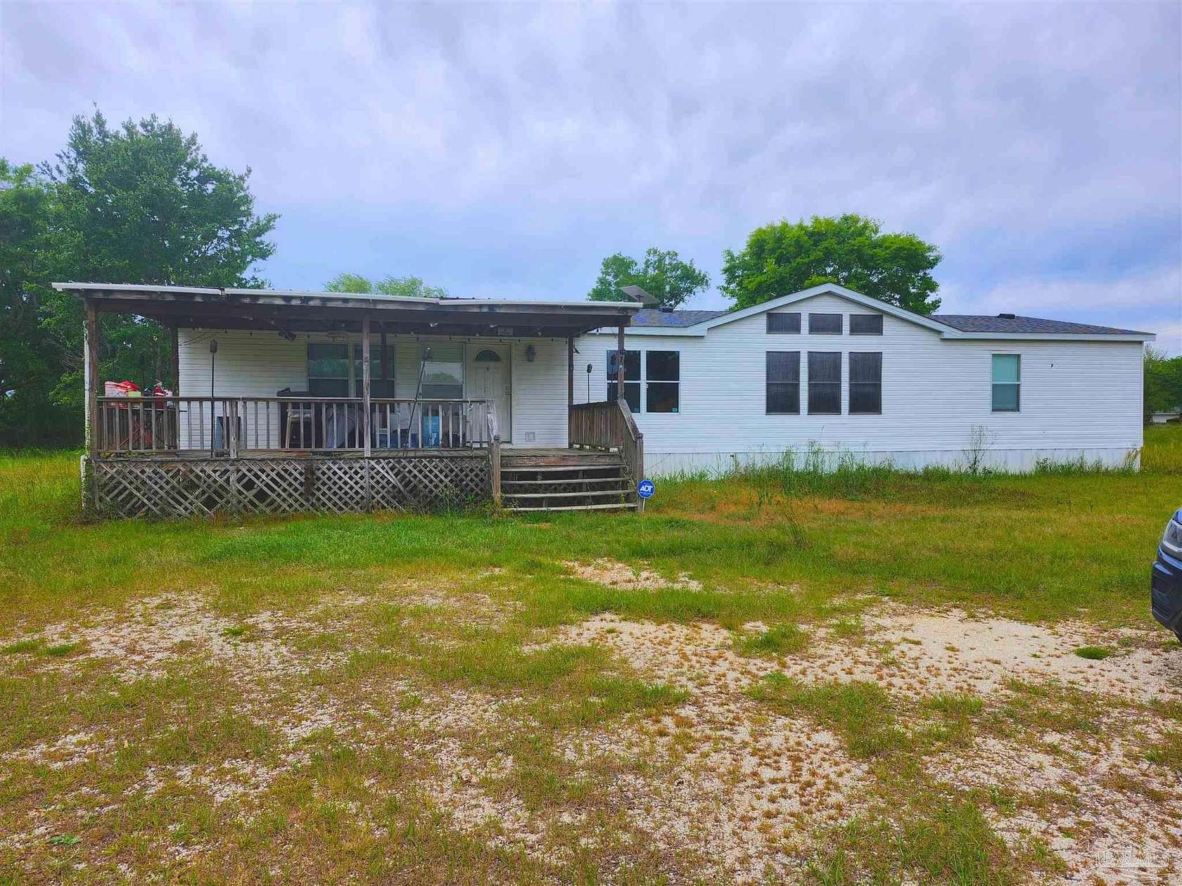 6.65 Acres of Land with Home for Sale in McDavid, Florida