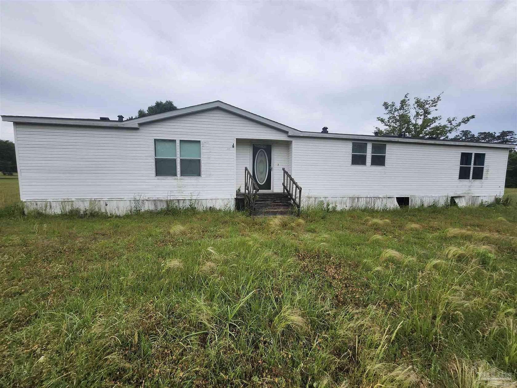 6.65 Acres of Land with Home for Sale in McDavid, Florida