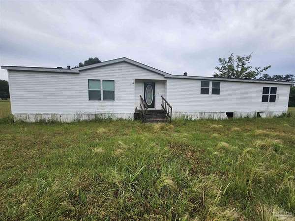 6.65 Acres of Land with Home for Sale in McDavid, Florida