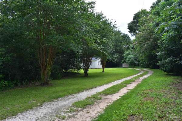4.88 Acres of Land with Home for Sale in McDavid, Florida