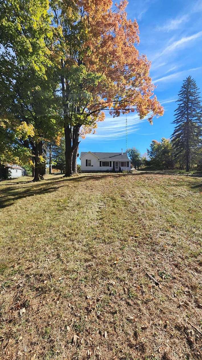 2 Acres of Land with Home for Sale in Comins, Michigan