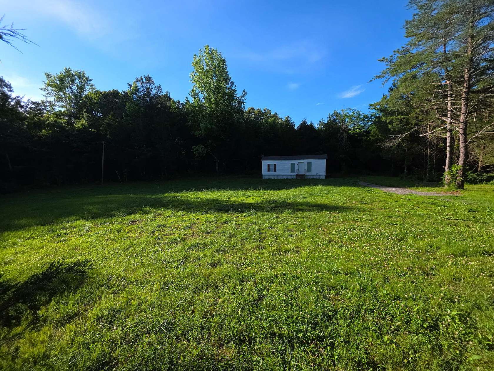 7.36 Acres of Land with Home for Auction in Calhoun, Tennessee