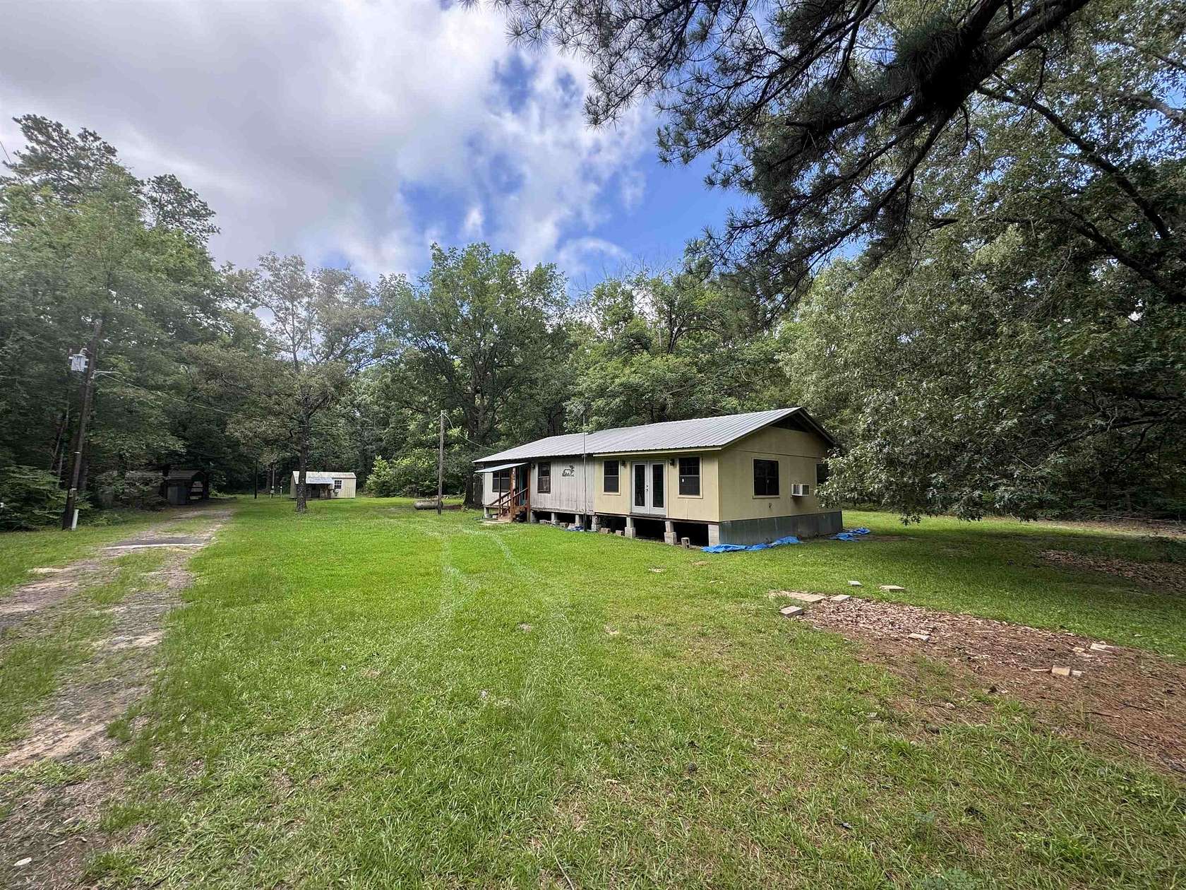 10 Acres of Land with Home for Sale in Carthage, Texas