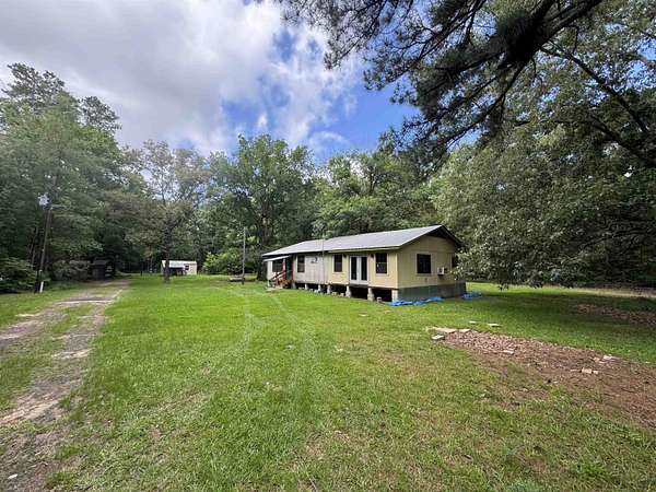 10 Acres of Land with Home for Sale in Carthage, Texas