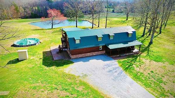 10 Acres of Land with Home for Sale in Holladay, Tennessee