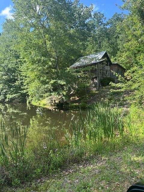 56.3 Acres of Recreational Land with Home for Sale in Eva, Tennessee
