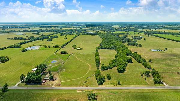 85.7 Acres of Agricultural Land with Home for Sale in Clarksville, Texas