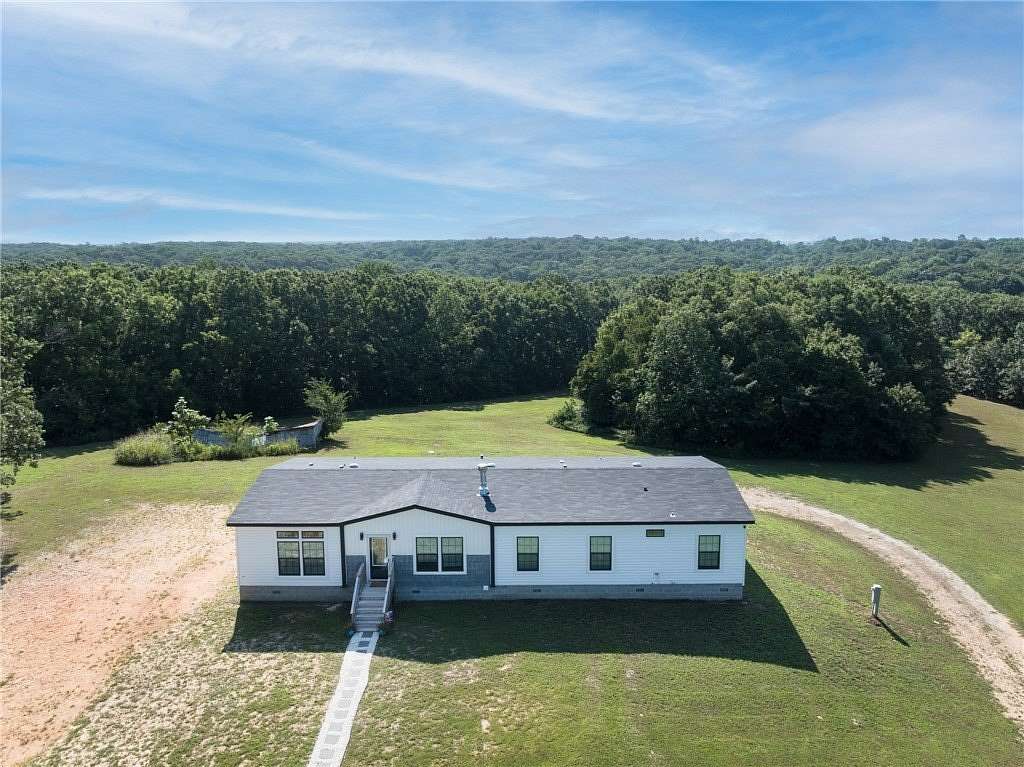 5.75 Acres of Land with Home for Sale in Gravette, Arkansas