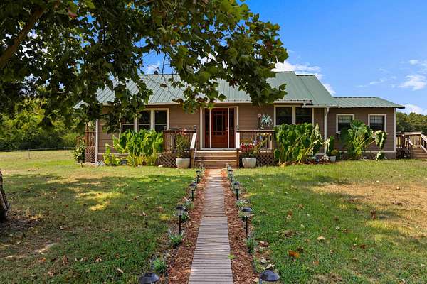 13.2 Acres of Land with Home for Sale in Avinger, Texas