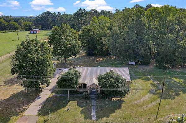 9.38 Acres of Land with Home for Sale in Carthage, Texas