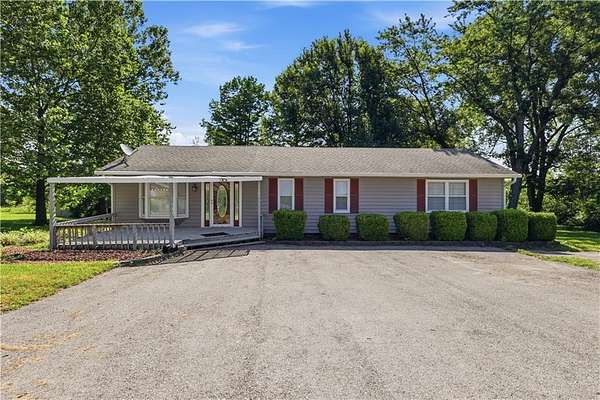 6.32 Acres of Land with Home for Sale in Peculiar, Missouri
