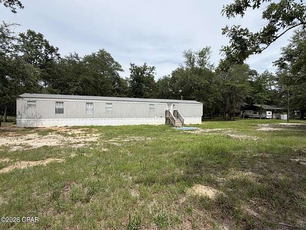 11.7 Acres of Land with Home for Sale in Sneads, Florida