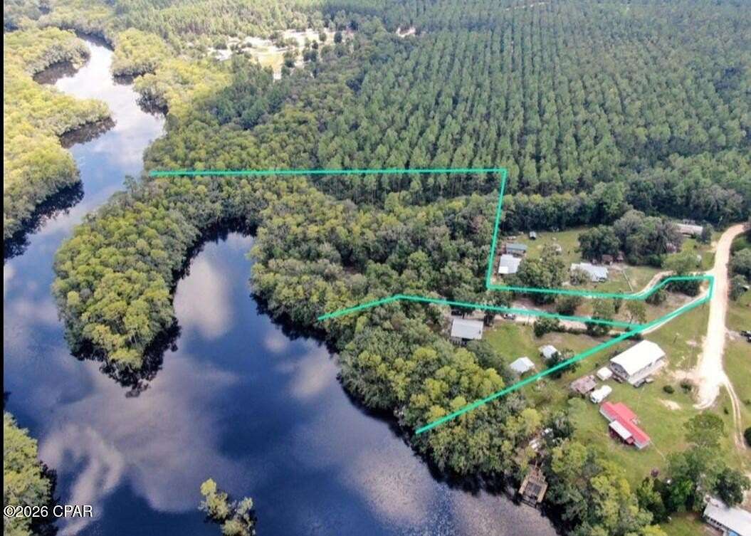 6.76 Acres of Land with Home for Sale in Ebro, Florida