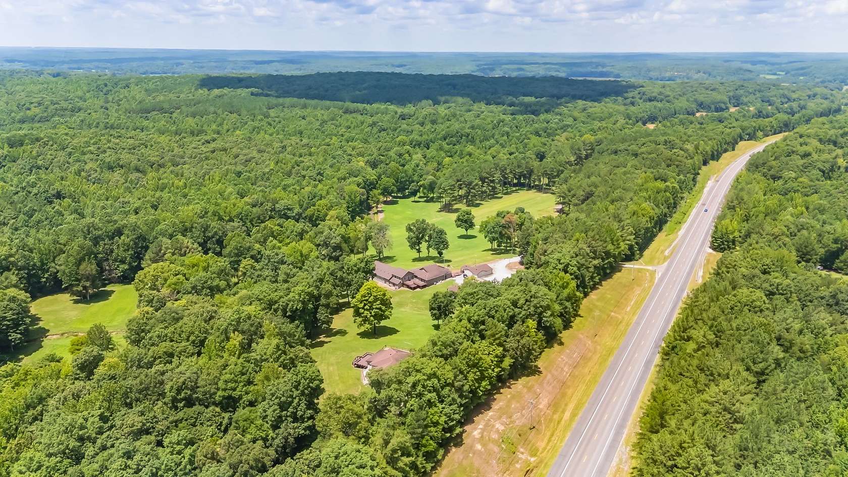 125 Acres of Land with Home for Sale in Holladay, Tennessee