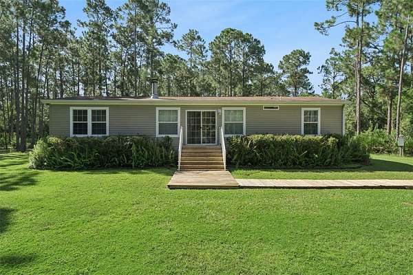 4.65 Acres of Land with Home for Sale in Mims, Florida