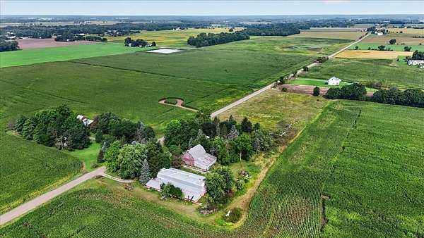 7.7 Acres of Land with Home for Auction in Webberville, Michigan