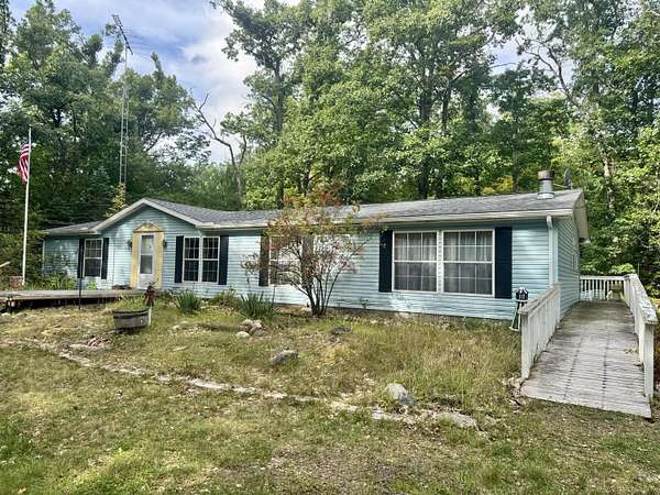 10 Acres of Recreational Land with Home for Sale in Comins, Michigan