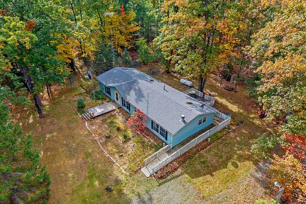 10 Acres of Recreational Land with Home for Sale in Comins, Michigan