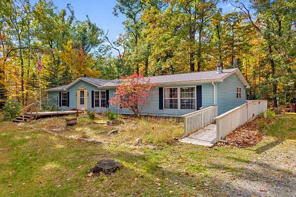 10 Acres of Recreational Land with Home for Sale in Comins, Michigan
