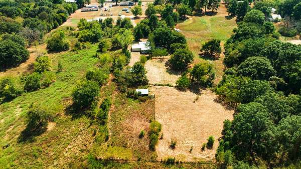 2.62 Acres of Land with Home for Sale in Arthur City, Texas