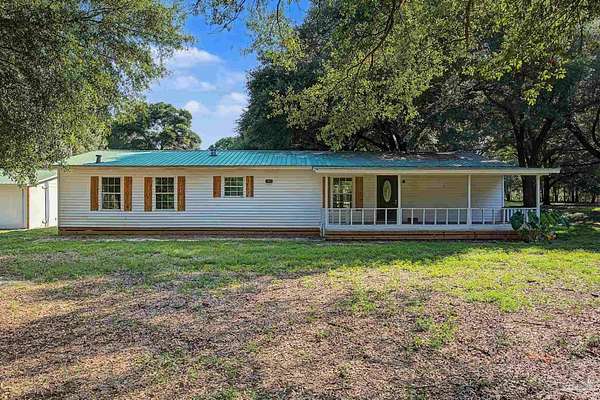 5.76 Acres of Land with Home for Sale in Holt, Florida