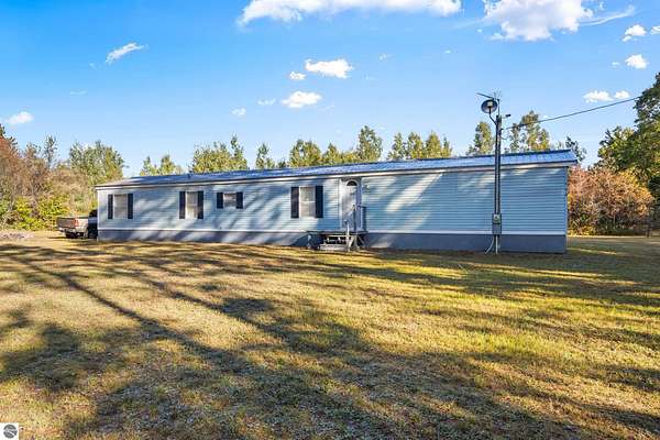10 Acres of Recreational Land with Home for Sale in Mancelona, Michigan