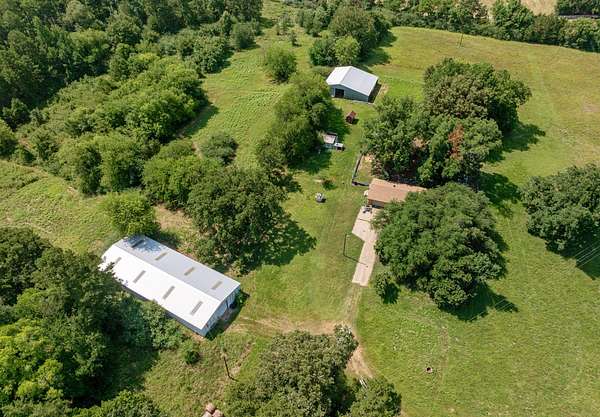 129 Acres of Land with Home for Sale in Ore City, Texas