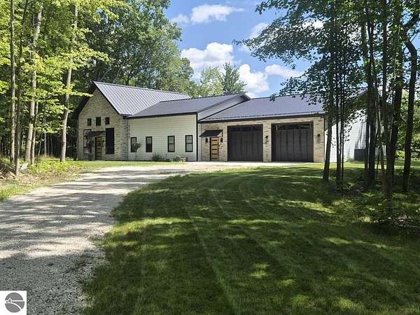 3 Acres of Land with Home for Sale in Canadian Lakes, Michigan