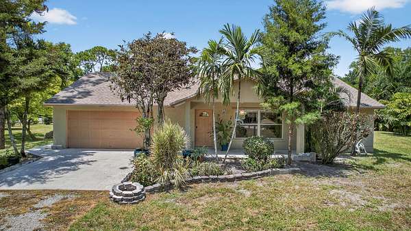 1.5 Acres of Land with Home for Sale in The Acreage, Florida