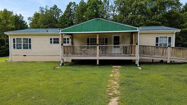 21.8 Acres of Recreational Land with Home for Sale in Camden, Tennessee