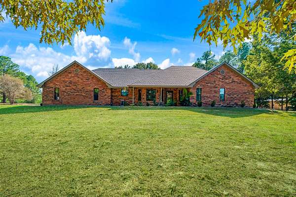 11.2 Acres of Recreational Land with Home for Sale in Powderly, Texas