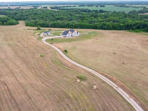 25 Acres of Land with Home for Sale in Wolfe City, Texas