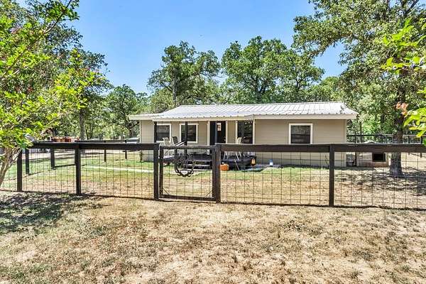 9.87 Acres of Land with Home for Sale in Bastrop, Texas