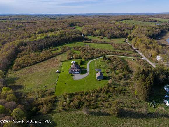 12 Acres of Land with Home for Sale in Thompson, Pennsylvania