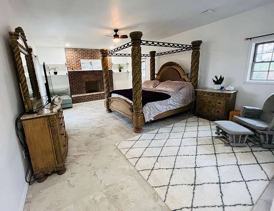 Large master bedroom with fireplace.
