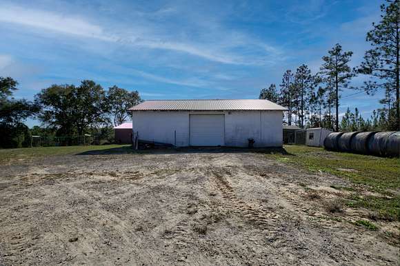 Mechanic shop/garage has plenty of room for a working business on the property.