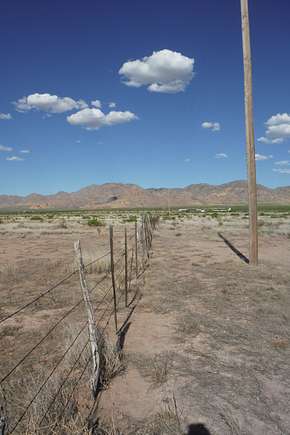 View to the east along southern fenceline of the acreage to the Peloncillo Mountains.