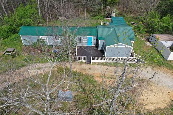 5.6 Acres of Land with Home for Sale in Lobelville, Tennessee