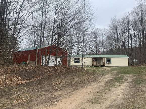 10 Acres of Recreational Land with Home for Sale in Mancelona, Michigan